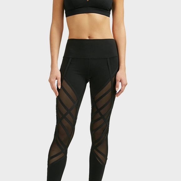 Alo Yoga High-Waist Wrapped Stirrup Legging in black with mesh panels. - Picture 3 of 7